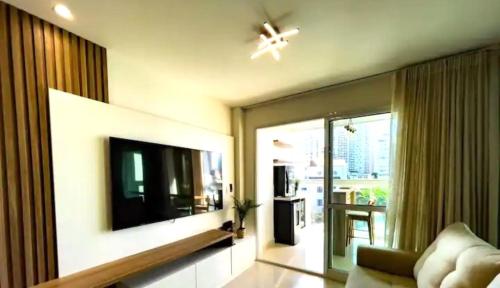 a living room with a flat screen tv on a wall at Apartamento Marina Vip in Salvador