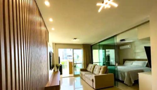 a bedroom with a bed and a couch in a room at Apartamento Marina Vip in Salvador