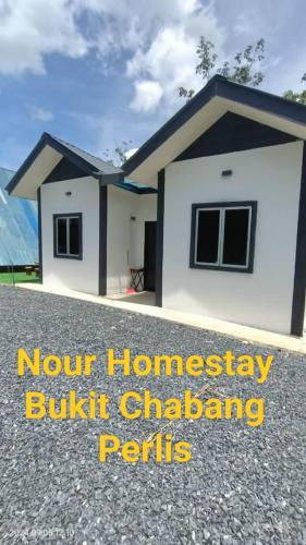 a small house is shown with the words newfound homesteading butkus challenger permits at Nour homestay Rumah B in Kaki Bukit