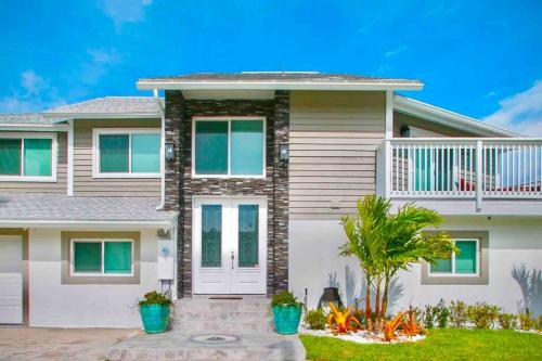 a house with a porch and a balcony at Spacious 4BR Beach House with Stunning Ocean Views in Cape Canaveral