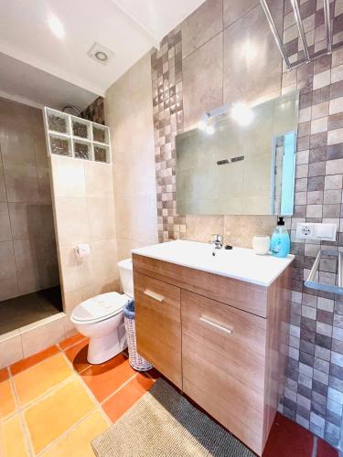 a bathroom with a sink and a toilet at Casita Acacia in Viñuela