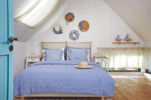 a bedroom with a bed with a hat on it at Miejscówka nad Morzem in Ciekocino