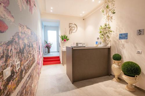 a room with a counter with flowers on the wall at Profumi di Primavera Luxury Rooms & Suite in Matera