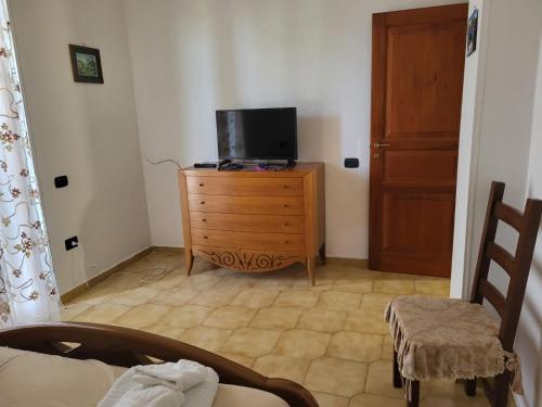 a living room with a tv on a wooden dresser at Appartamento Fotia in Giugliano in Campania