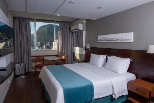 a hotel room with a bed and a window at Sol Ipanema Hotel in Rio de Janeiro