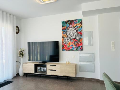 a living room with a flat screen tv on a wall at Alicante City Beach Jacuzzi Luxury Penthouse with Rooftop Terrace in Gran Alacant