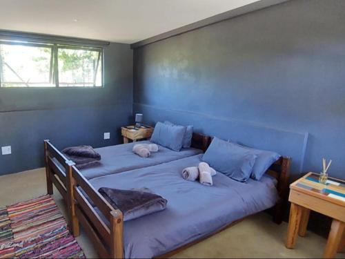 a bedroom with two beds with stuffed animals on them at La Hacienda in uMhlali