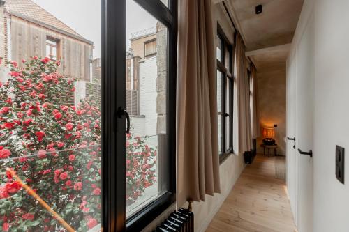 a window with a view of a flower bush at BTFL Living Antwerp in Antwerp