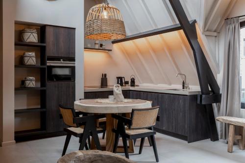 a kitchen with a table and chairs and a sink at BTFL Living Antwerp in Antwerp