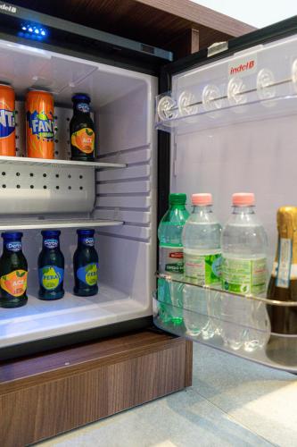 an open refrigerator filled with lots of bottles of soda at Profumi di Primavera Luxury Rooms & Suite in Matera
