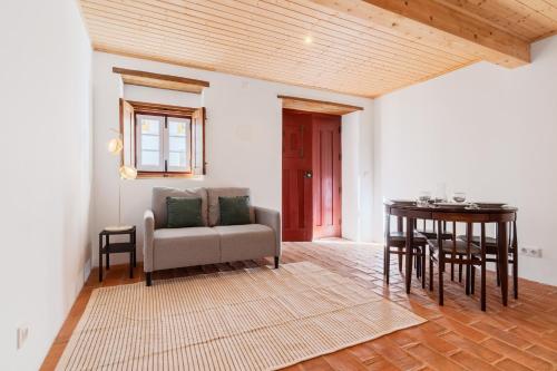 a living room with a couch and a table at Casas Miguel Bombarda in Castelo de Vide