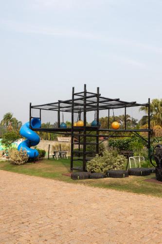 a playground with a blue slide in a park at Valinhos Plaza Hotel in Valinhos