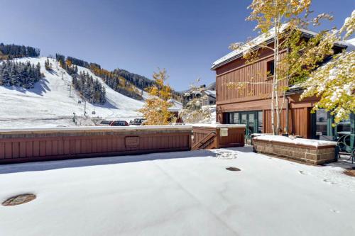 a house with snow on the ground in front of it at Village Hall 12 by East West Hospitality in Beaver Creek