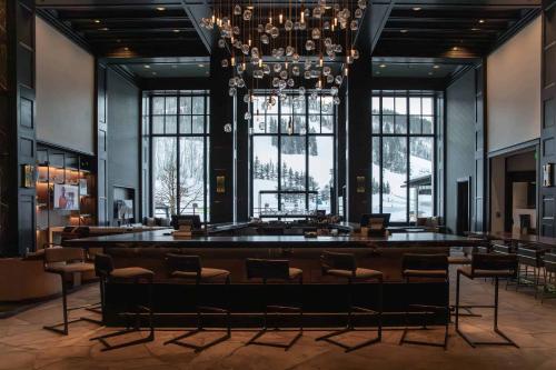 a large room with chairs and a large chandelier at Village Hall 09 by East West Hospitality in Beaver Creek
