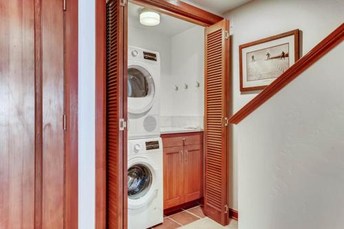 a laundry room with a washer and dryer at Village Hall 12 by East West Hospitality in Beaver Creek