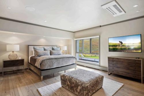 a bedroom with a bed and a large window at Village Hall 09 by East West Hospitality in Beaver Creek