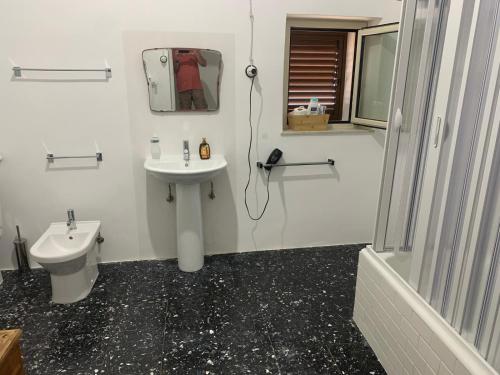 a white bathroom with a sink and a toilet at Bed & Breakfast StudioArcodia- in San Marco dʼAlunzio