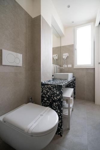 a bathroom with a toilet and a sink at Profumi di Primavera Luxury Rooms & Suite in Matera
