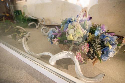 a reflection of a bouquet of flowers in a window at Profumi di Primavera Luxury Rooms & Suite in Matera