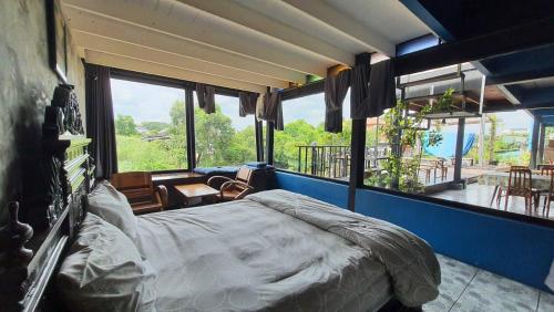 a bedroom with a large bed and a balcony at Baan mae khian homestay in Phra Nakhon Si Ayutthaya