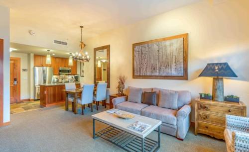 a living room with a couch and a table at Capitol Peak Lodge 3217 by Snowmass Mountain Lodging in Snowmass