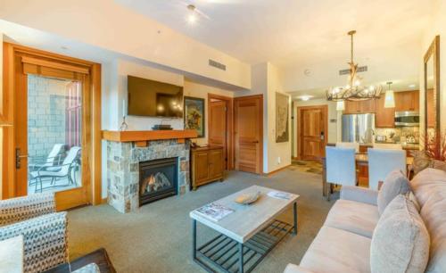a living room with a couch and a fireplace at Capitol Peak Lodge 3217 by Snowmass Mountain Lodging in Snowmass