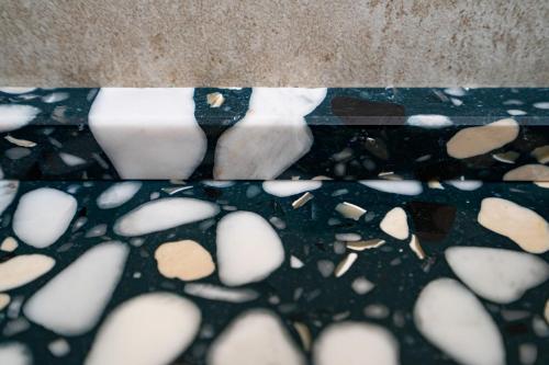 a close up of a black and white floor with rocks at Profumi di Primavera Luxury Rooms & Suite in Matera