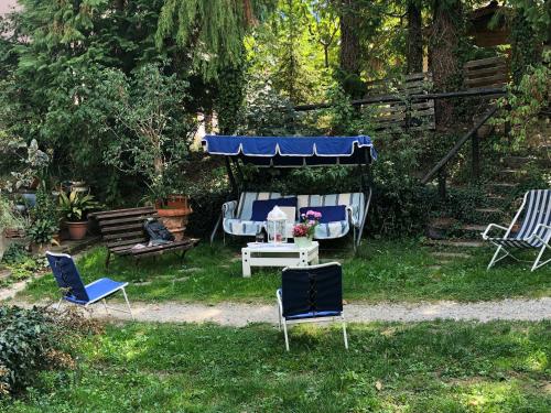 a group of chairs and a table in a yard at Villa Fedora in Lizzano in Belvedere