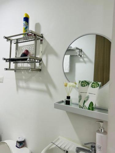 a bathroom with a mirror and a sink and a mirrorphasis at Jasrich Suite Behind SM trece martires HOPE RESIDENCES SMDC in Cavite
