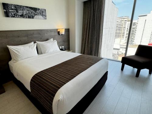a hotel room with a large bed and a window at Best Western Plus Urban Larco Hotel in Lima