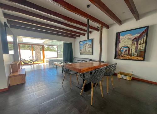 a dining room with a wooden table and chairs at San Jose de Puembo Quito Airport, an Ascend Collection Hotel in Puembo