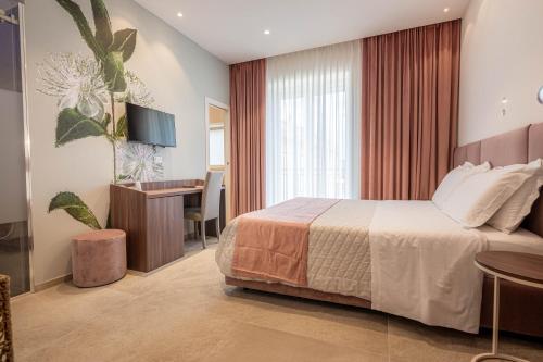 a hotel room with a bed and a desk at Profumi di Primavera Luxury Rooms & Suite in Matera
