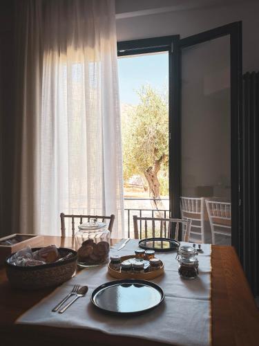 a dining room table with a view of a window at Dimora Harmonia in Carini
