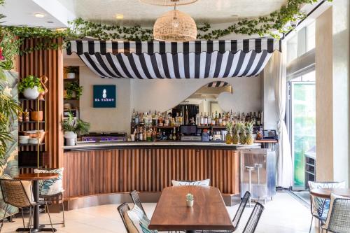 a restaurant with a bar with a table and chairs at The Dominick Hotel in New York