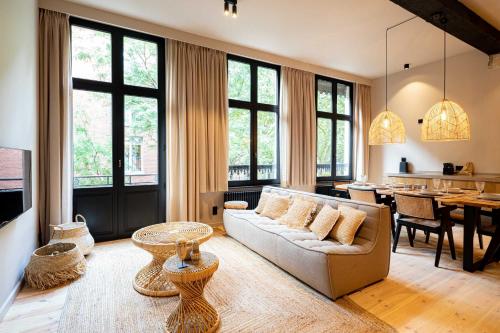 a living room with a couch and a table at BTFL Living Antwerp in Antwerp