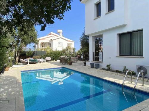 a swimming pool in front of a house at Villa Mulberry - Kyrenia North Cyprus in Lapithos