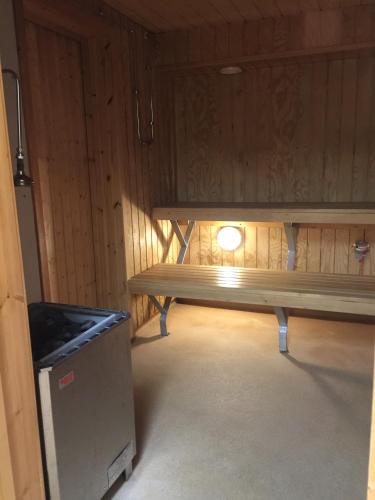 a bench in a room with a light on it at STF Malmfältens Folkhögskola in Kiruna