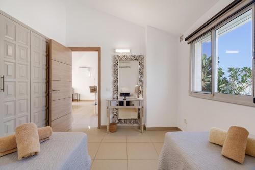 a bedroom with two beds and a large window at Casa Zara in San Miguel de Abona