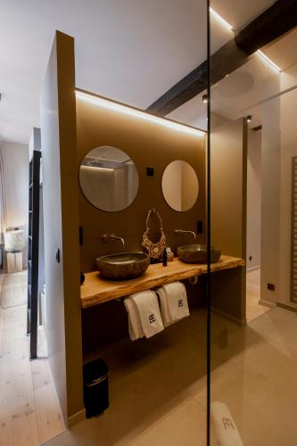 a bathroom with two sinks and two mirrors at BTFL Living Antwerp in Antwerp