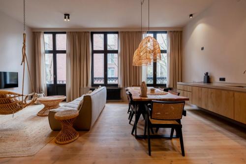 a living room with a couch and a table at BTFL Living Antwerp in Antwerp