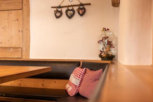 two pillows sitting on a bench next to a table at Gasthaus Amboss in Ravensburg