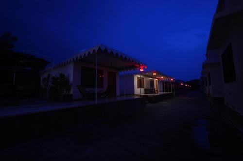 a night view of a building with a dark sky at The Sky Imperial Nakoda Green Valley Resort in Nāthdwāra