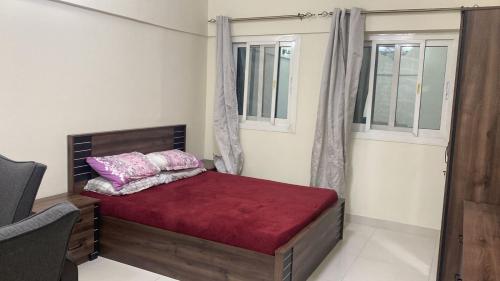 a bedroom with a bed and two windows at Private room for ladies near metro in Dubai