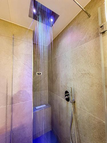 a shower with a glass door in a bathroom at Profumi di Primavera Luxury Rooms & Suite in Matera