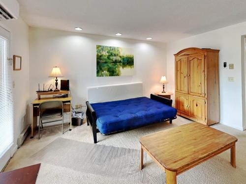 a bedroom with a blue bed and a desk at Deep Creek Village #31 in McHenry