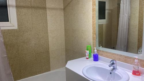 a bathroom with a sink and a mirror at Private room for ladies near metro in Dubai
