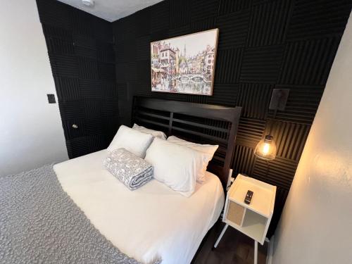 a bedroom with a bed with white sheets and pillows at Pura Vida Private Access, Room & Bathroom in West Palm Beach