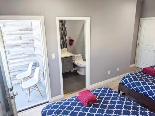 a bedroom with a mirror and a bed and a bathroom at Lucky Charm 4 Bedroom Mid-City Apartment in Los Angeles