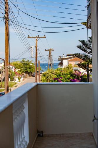 a balcony of a house with a view of the ocean at Katakolo Apartments near Olympia in Katakolon