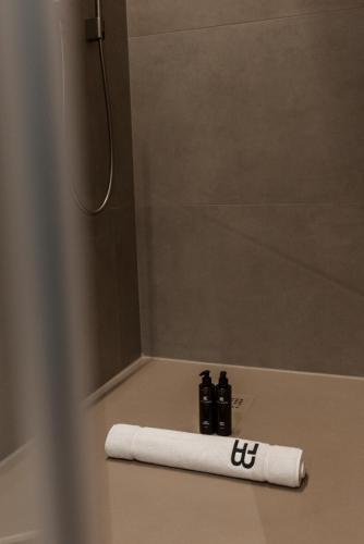 a roll of toilet paper sitting on the floor of a shower at BTFL Living Antwerp in Antwerp